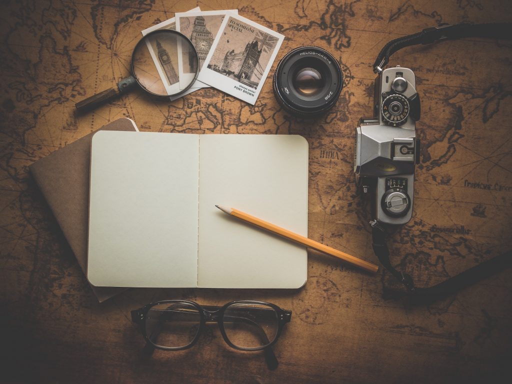 glasses, notebook and magnifying glass 