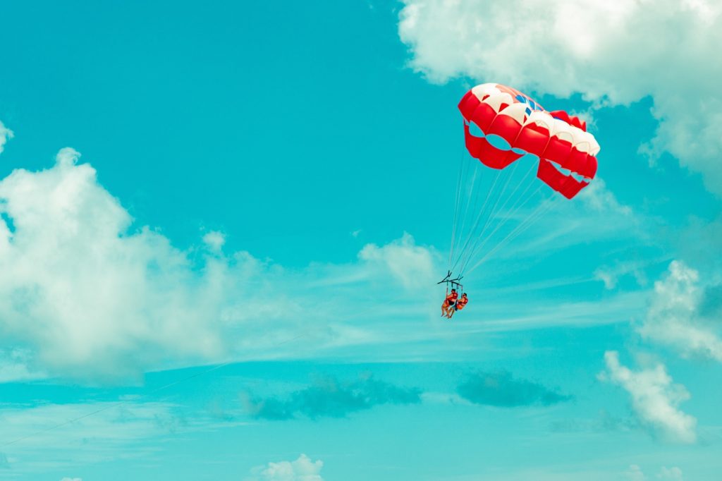 people landing on a parachute 