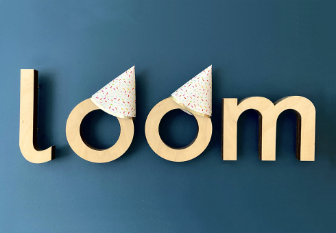 Loom logo with party hats